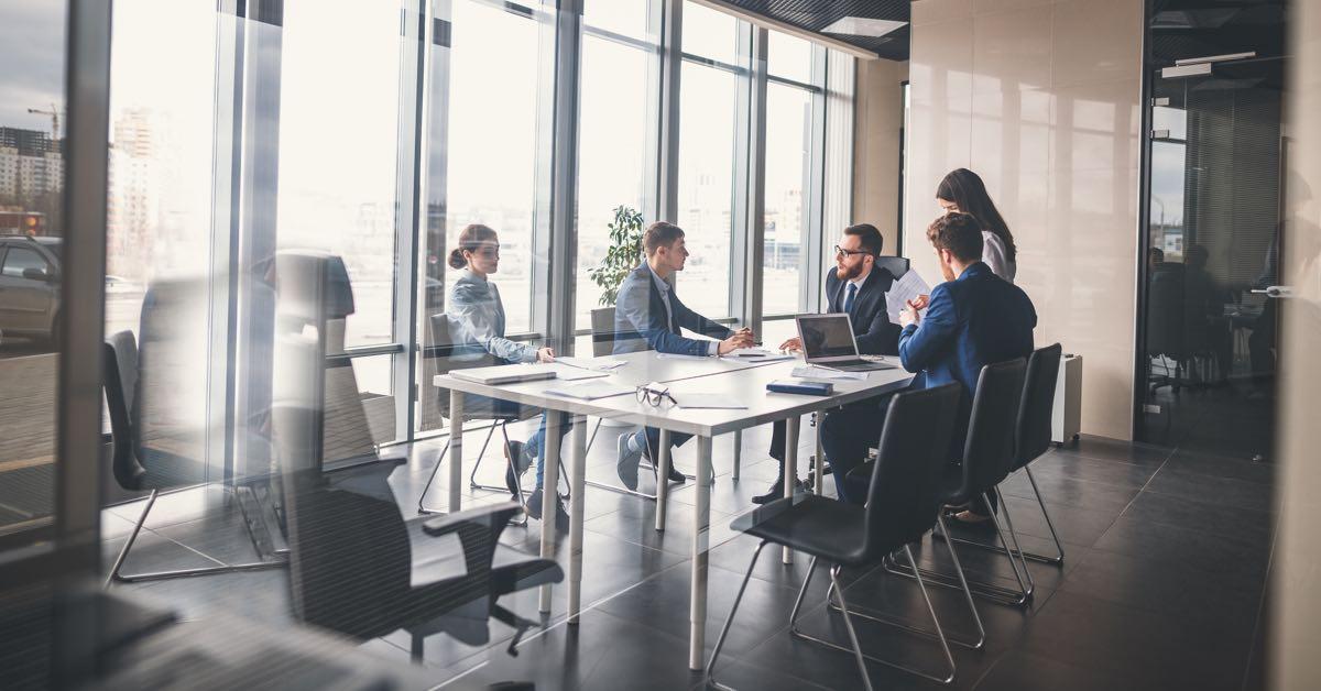 Photograph of a revenue operations team sitting at a conference table