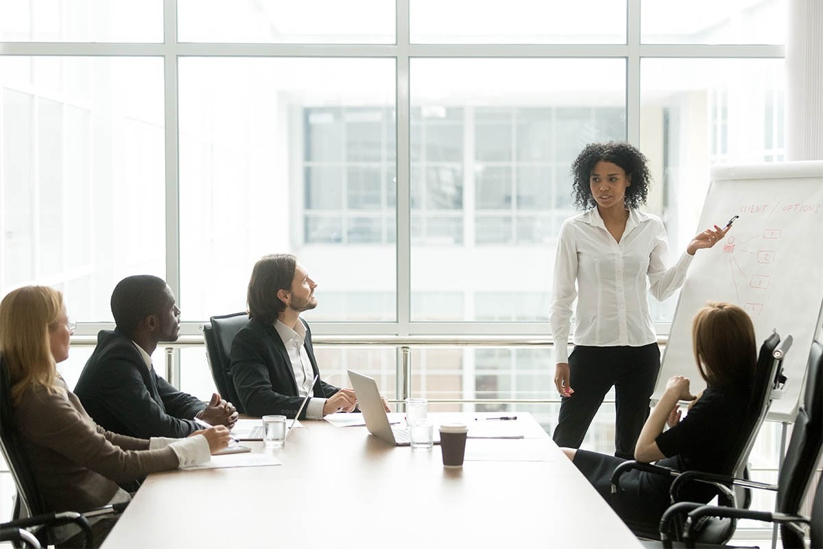 Photograph of a person presenting to a group of sales and marketing leaders about alignment strategies